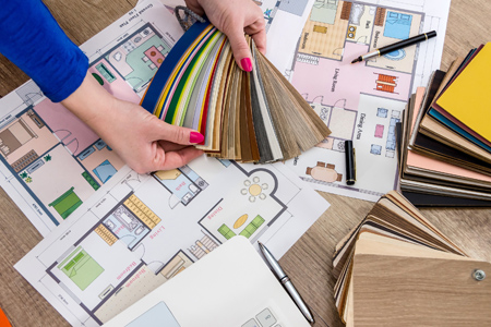 Close-up Of A Person's Hand Holding Colorful House Plan