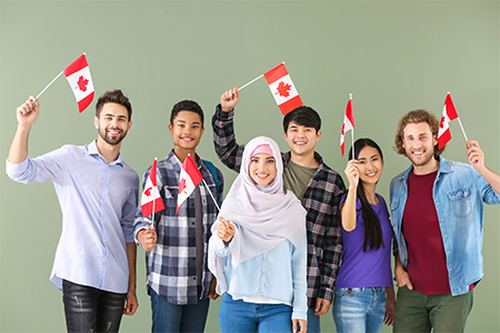 Group of adults with Canadian flags on color background