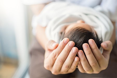 Close up hands holding newborn baby, copy space banner family concept