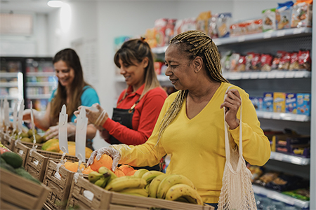 senior woman buying fresh fruits at mini market