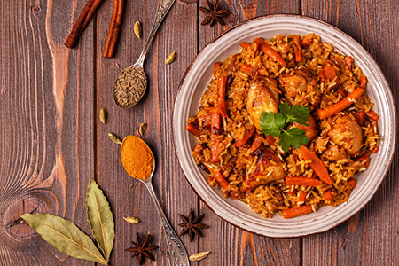 Pilaf (biryani) on a wooden background, top view,