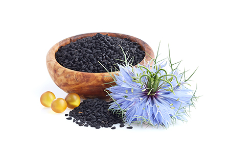 Black cumin seeds with oil capsules in white background