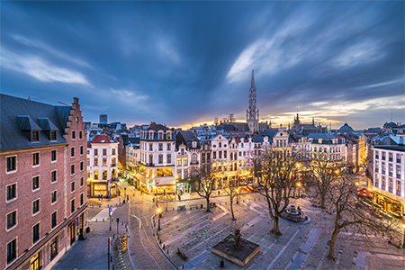 Brussels, Belgium plaza and skyline with the Town Hall tower at dusk