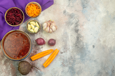 Free photo top view of a pot with delicious borscht soup and different vegetables wooden spoon on a 