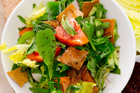 fattoush salad on white plate - top view