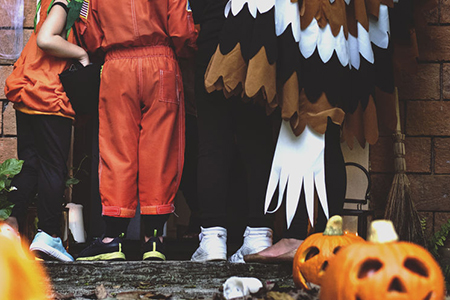 Little children trick or treating on Halloween