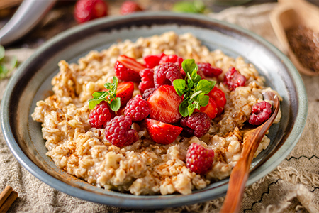 Delicious porridge with fresh berries, cinnamon and mint