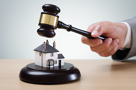 Bidding on a home, gavel and house concept for home ownership, buying, selling or foreclosure