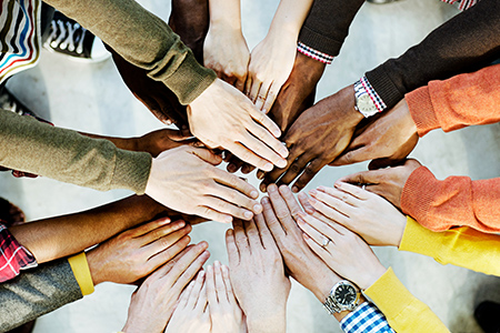 Group of diverse hands together joining concept