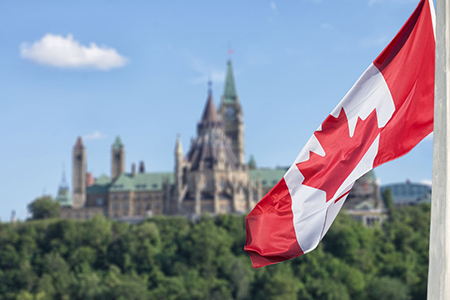 Canada flag with Parliament building in the background