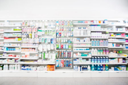 Defocused image of medicines arranged in shelves at pharmacy