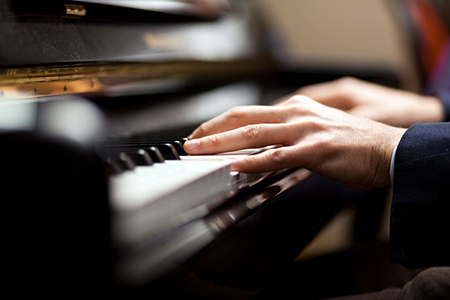 Close up of a musician playing a piano keyboard