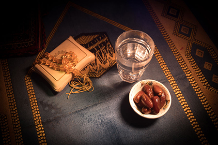 dates and quran on prayer rug