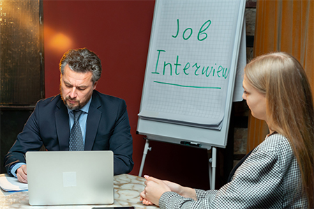 an interview of a young girl with the recruiter of the company