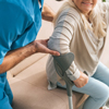 A nurse helping senior woman with crutches