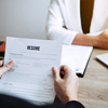 Job applicants are holding a resume document in the job interview room, job interview concept