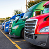 Colorful Pickup trucks parked in a parking lot.