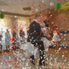 Bride and groom dancing the first dance at their wedding day. Guest on the dancefloor