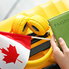 Woman with passport, Canadian flag and luggage, closeup. Travel and immigration concept