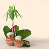 two pongal pots with banana leaf background 