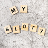 My Story written with wooden letter blocks on a stone background