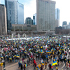 Toronto, Ontario, Canada â€“ February 27, 2022: Protestors with banners and Ukrainian flags in Downt