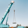 a large blue car crane prepared for an operation