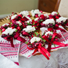 Bunch of beautiful wedding boutonnieres tied with ribbons laying on the golden tray