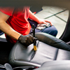 man carefully cleans the interior of a car with a rag a brush vacuum cleaner steamer detailing close