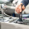 cleaning the interior of a luxury car with a brush