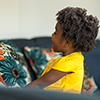 African American mother playing and talking with her daughter.