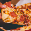 Close-Up Photo of Person Holding Pizza