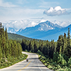 motorcycle on road - rocky mountain in the distance