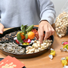 Woman fill with snack of the box for Iranian New Year