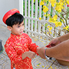 Grandfather giving lucky money to grandson on the first day of Vietnamese lunar new year Tet