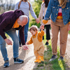 toddler with parents and grandparents on a walk outdoors