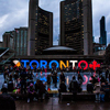 People Gathered in Front of Toronto Freestanding Signage