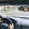 Young cheerful person driving car