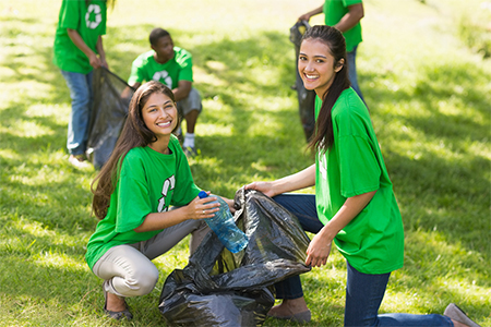 A vibrant voluntary community clean-up day brings together enthusiastic volunteers clad in green shi