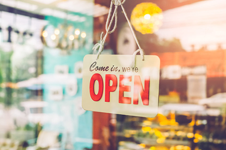 Open sign broad through the glass of door in cafe. Business service and food concept. Vintage tone f