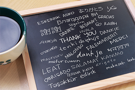 Thank you gratutide words letter in many languages, written on blackboard. Motivational business typ