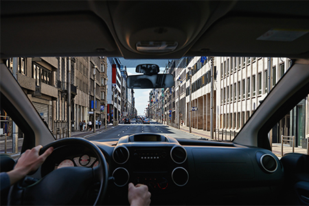 Young driver inside car on the city road