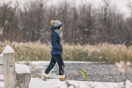 Winter snow happy cold weather girl walking in snowing forest