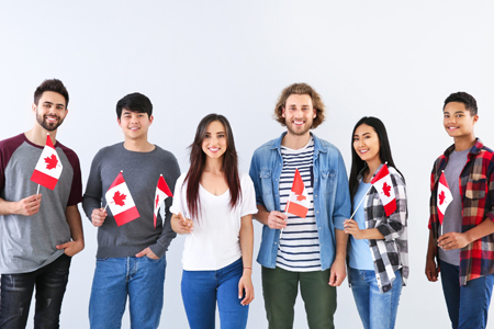 Group of students with Canadian flags on light background