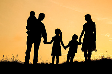 happy family by the sea on nature silhouette background