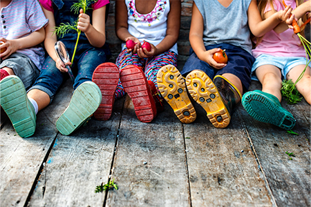 Group of kindergarten kids little farmers learning gardening