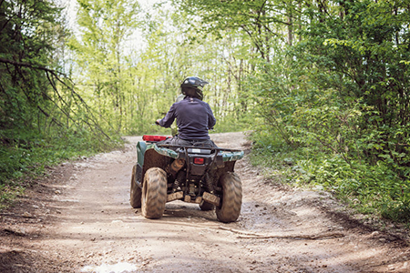 Man on the ATV Quad Bike on the mountains road.