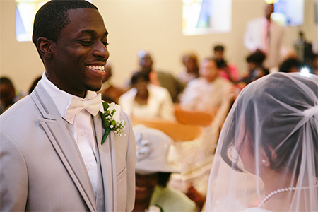 Bridegroom in church wedding ceremony smiling at bride