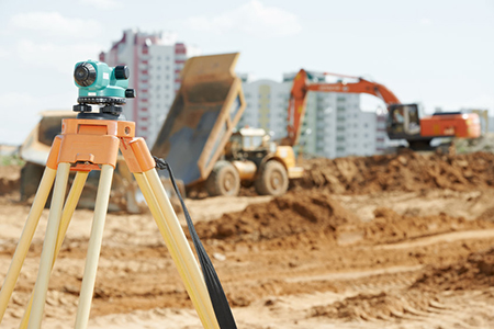 Surveying measuring equipment level theodolite on tripod at construction building area site