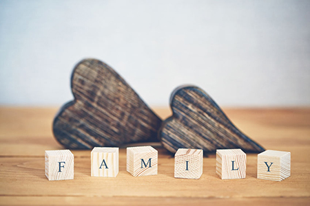 wooden hearts - blocks in foreground spelling out family